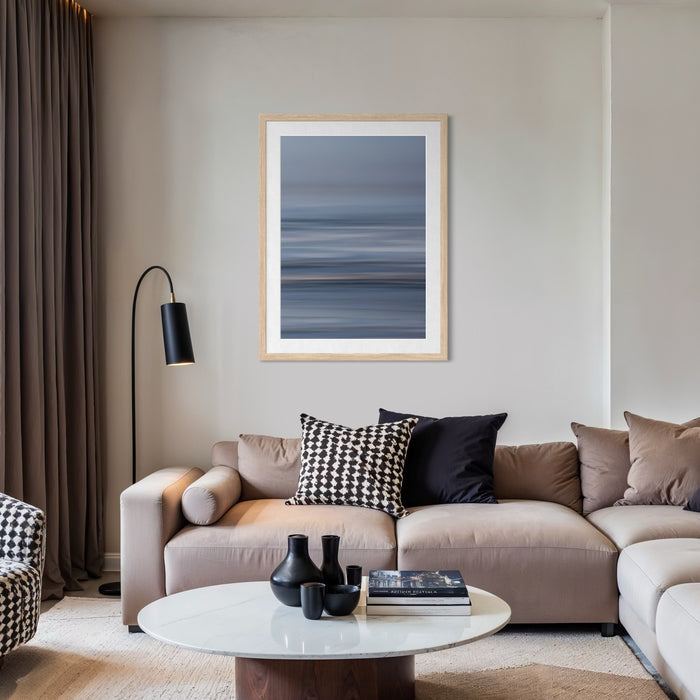 The artwork "Bluff Cove" by Neil Shapiro features a tranquil, abstract seascape with layered horizontal bands in shades of muted blues and grays. The smooth, flowing textures evoke a serene coastal atmosphere, reminiscent of minimalist landscapes by Mark Rothko and the subtle tonal gradations found in Hiroshi Sugimoto’s photography.
