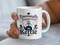 White mug with "Emotionally Supported By The Kettle" text and Scottish thistle design.
