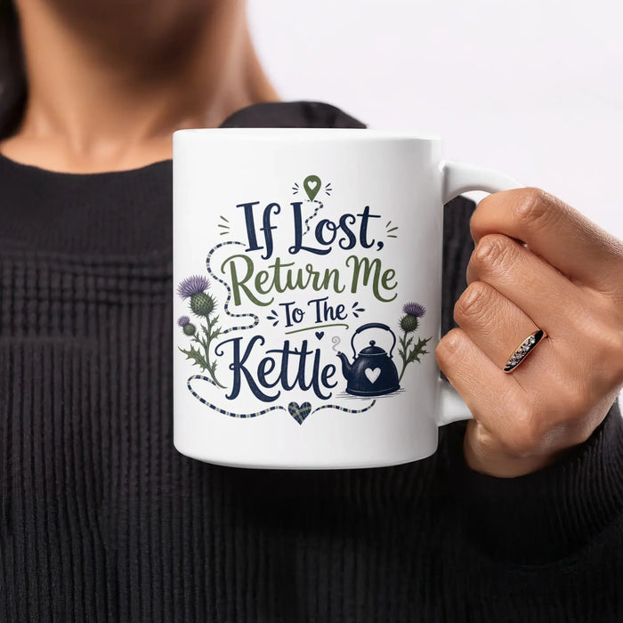 White mug with "If Lost, Return Me To The Kettle" text, thistle, and kettle illustration.