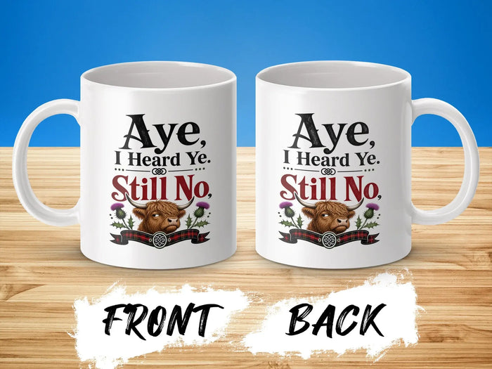 Mug with Highland cow graphic and "Aye, I Heard Ye. Still No." text.