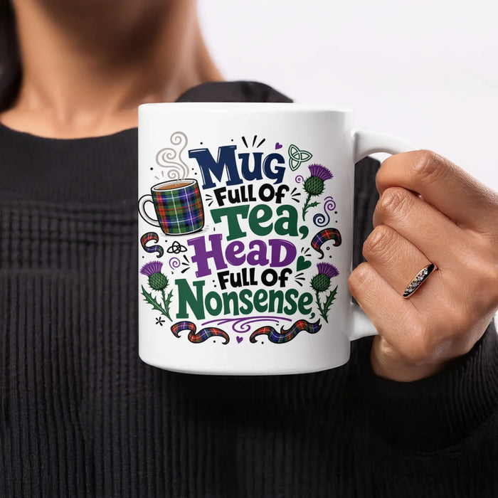 White mug with "Mug Full of Tea, Full of Nonsense" text and plaid pattern.