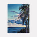 The artwork 'Solitude' by Claudia Robles-Gil captures a serene tropical seascape with a prominent palm tree framing the composition. Rich turquoise waters meet a dreamy sky filled with billowing clouds in shades of blue and pink. The palm fronds cast delicate shadows against the luminous sunset backdrop, creating a peaceful coastal atmosphere. Oil and acrylic on canvas, 24x18 inches.