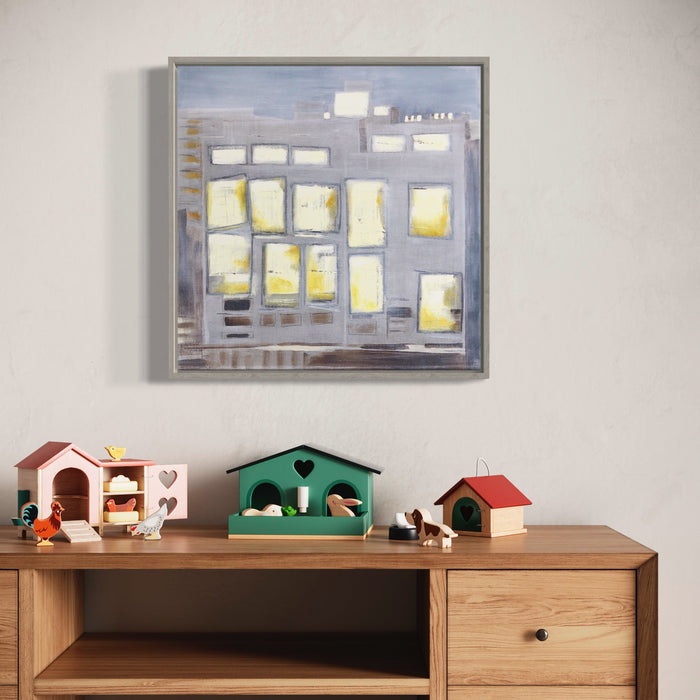 The artwork 'Sunset in the East-2' by Cora Jane Glasser features an abstract geometric composition of illuminated yellow rectangles against a misty gray background, reminiscent of city windows at dusk. The 20x20 inch oil painting on linen showcases a modernist grid pattern with warm glowing elements contrasting against cool tones, framed in a contemporary style.